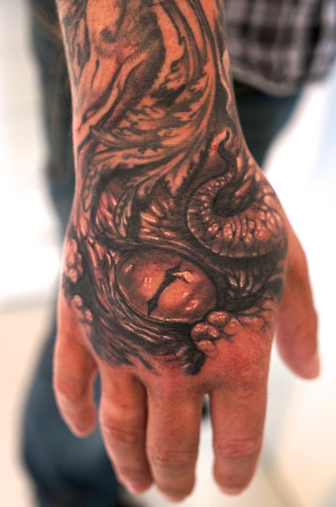 Snake eyes tattoo on the hand by graynd